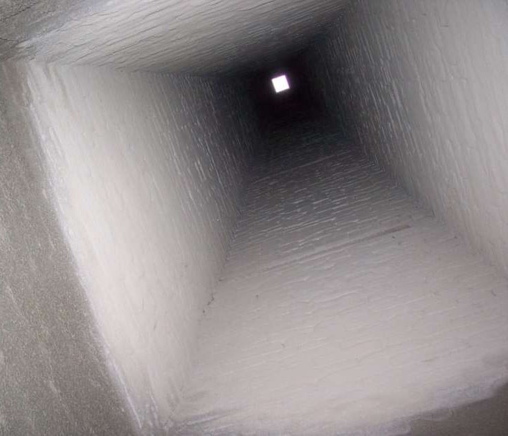 Inside view of a chimney shaft after being lined with Thermocrete, showcasing a smooth, sealed surface.